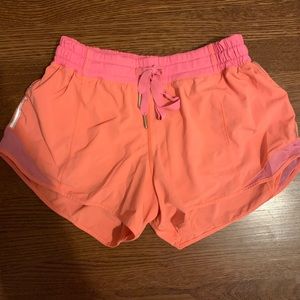 Orangey pink lululemon hotty hot 4” shorts